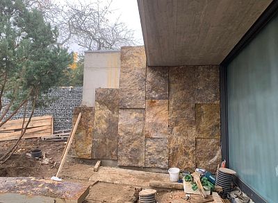 Instalace megalitických obkladů z pískovce na stěnách moderní budovy v lokalitě Praha – Zdiby