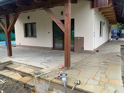 Realizace anglické pískovcové dlažby kolem domu, bazénu a pod dřevěnou pergolou v Lanžově